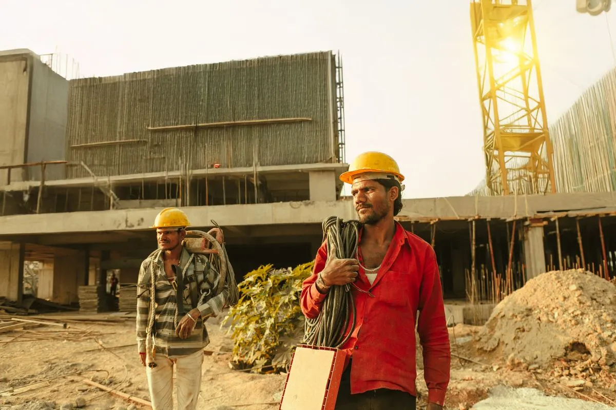 Two construction workers at a building site in India